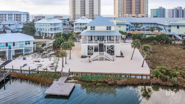 back of property featuring a water view