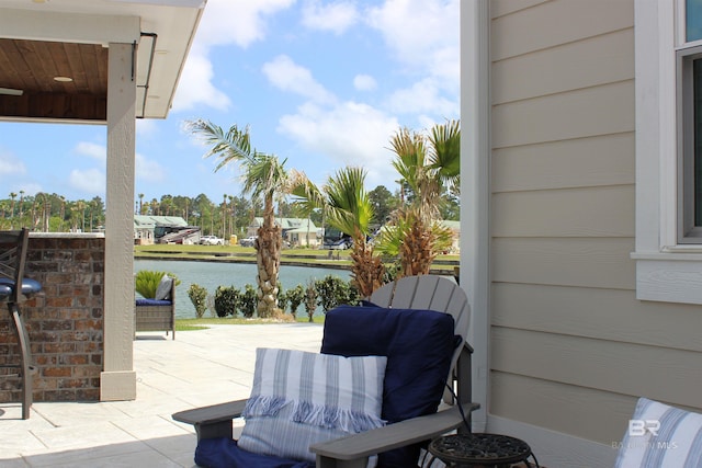 view of patio with a water view