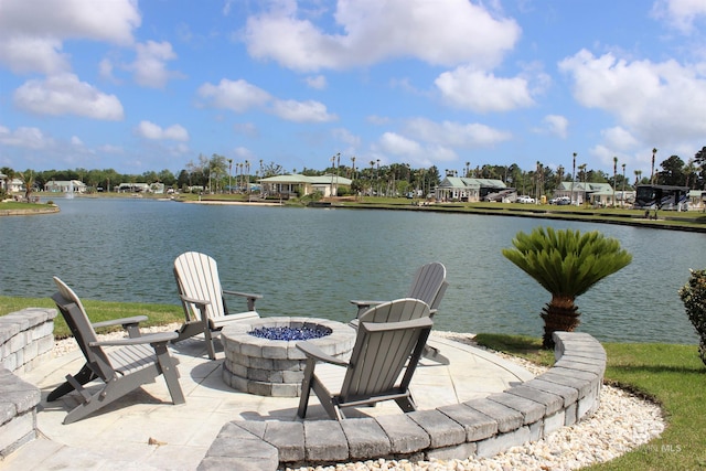 view of dock featuring a fire pit, a patio area, and a water view