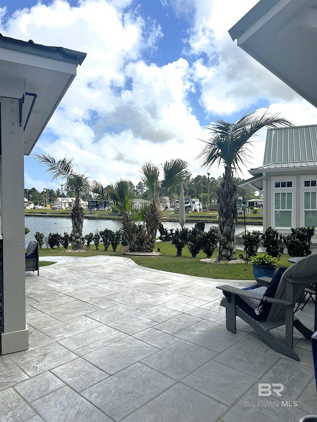 view of patio with a water view