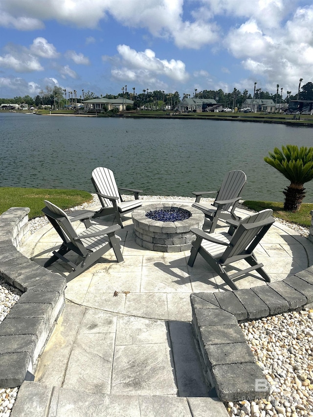 view of dock with a water view, a patio, and an outdoor fire pit