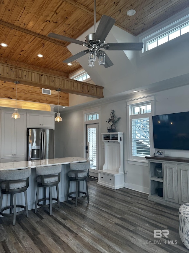 kitchen featuring stainless steel fridge with ice dispenser, visible vents, wood ceiling, high vaulted ceiling, and dark wood-style flooring