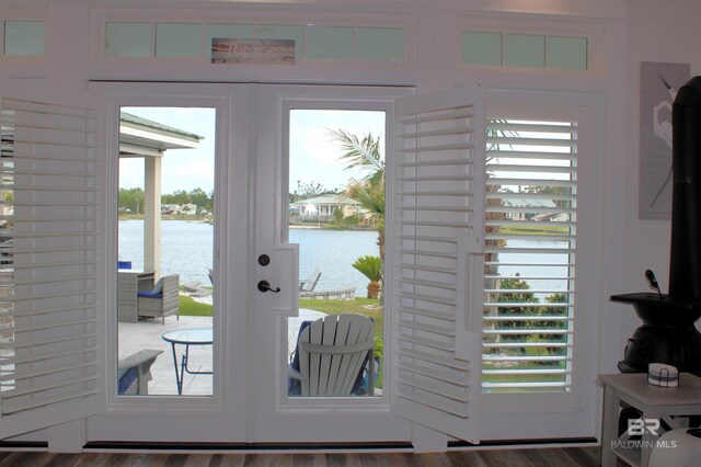 doorway to outside with a water view and french doors