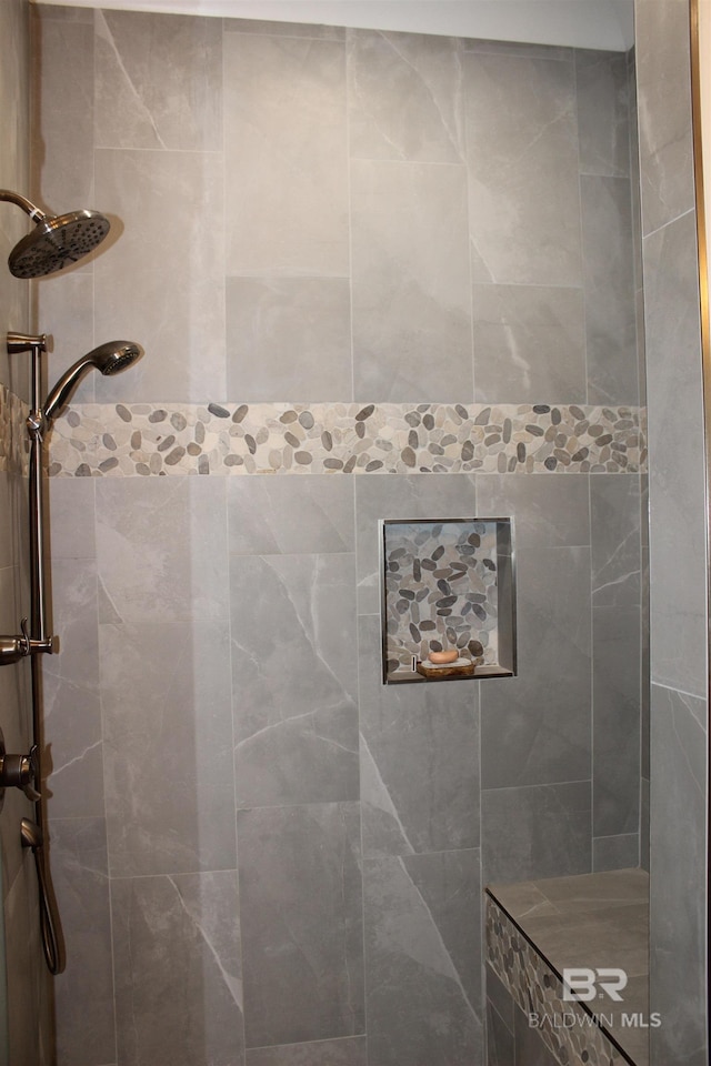 bathroom with a tile shower
