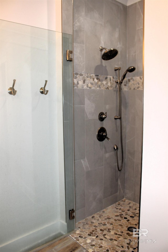 full bath featuring a shower stall