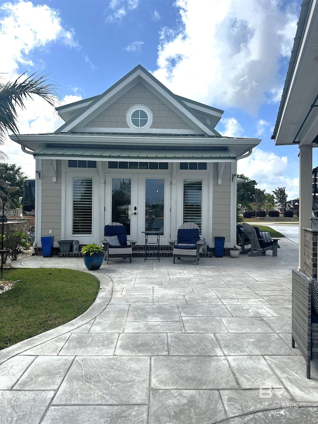 rear view of property with french doors and a patio