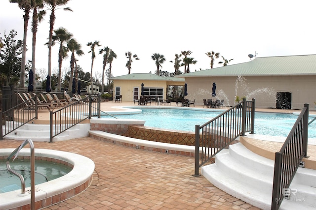 community pool with a community hot tub and a patio area