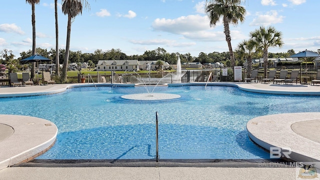 pool featuring fence and a patio area