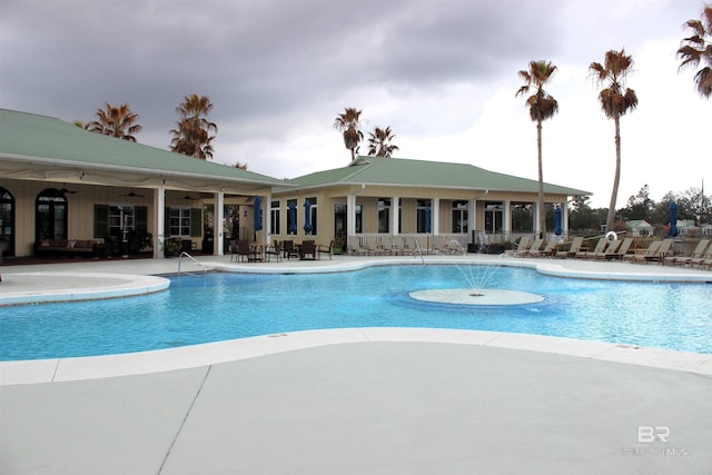 community pool with a patio and ceiling fan