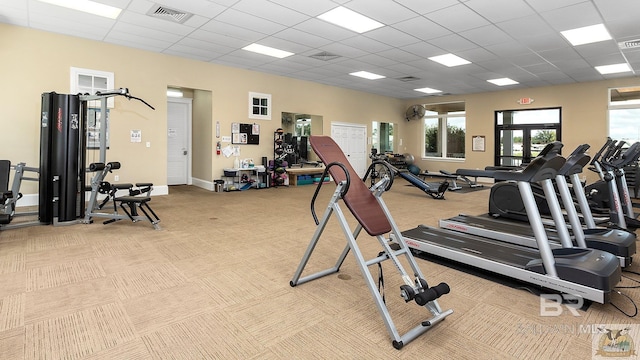 exercise room featuring light carpet, visible vents, and a drop ceiling
