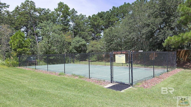 view of sport court featuring fence and a lawn