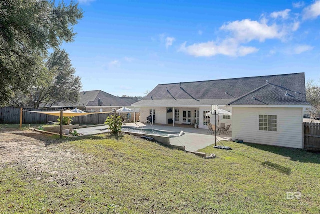 back of property with a patio area and a lawn