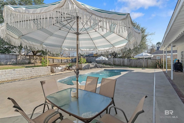 view of pool featuring pool water feature and a patio