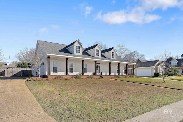 cape cod house with a garage, covered porch, and a front yard