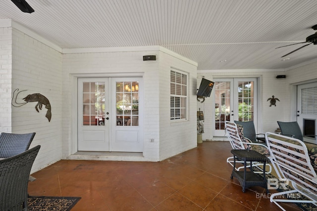 exterior space with a patio, french doors, a ceiling fan, and brick siding