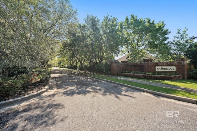 view of road with sidewalks and curbs
