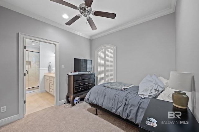 bedroom featuring baseboards, ornamental molding, ceiling fan, ensuite bath, and light colored carpet