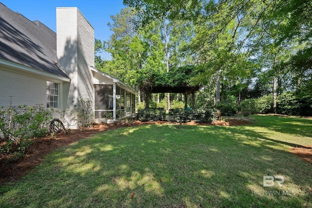 view of yard featuring a sunroom