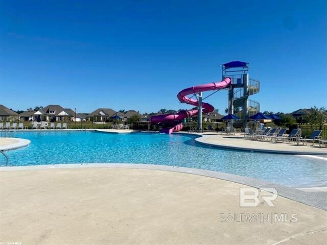 11006 Secretariat Blvd, Daphne, AL 36526 - community pool with a water slide, fence, and a patio area
