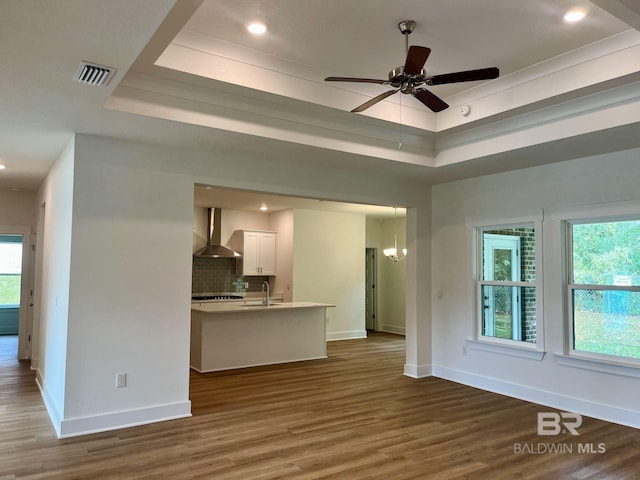 11006 Secretariat Blvd, Daphne, AL 36526 - unfurnished living room featuring a raised ceiling, a sink, baseboards, and recessed lighting