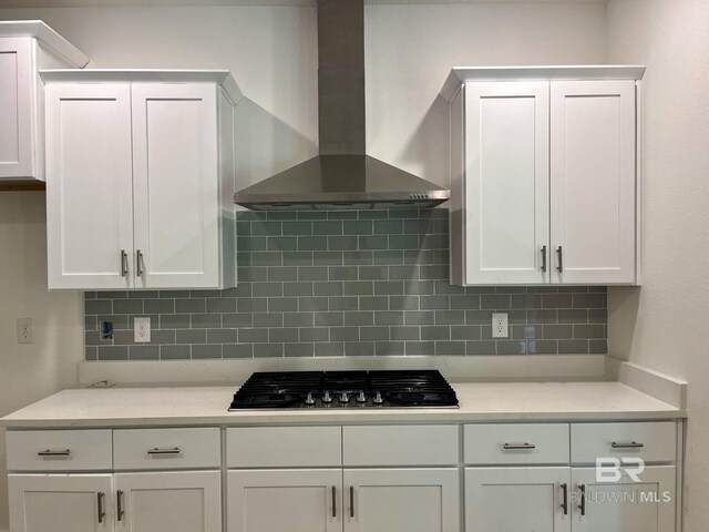 11006 Secretariat Blvd, Daphne, AL 36526 - kitchen featuring wall chimney range hood, gas stovetop, white cabinets, and backsplash
