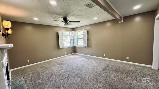 empty room featuring a textured ceiling, beam ceiling, ceiling fan, and carpet floors