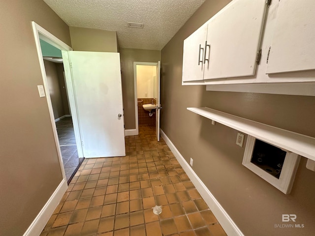 interior space featuring tile floors and a textured ceiling