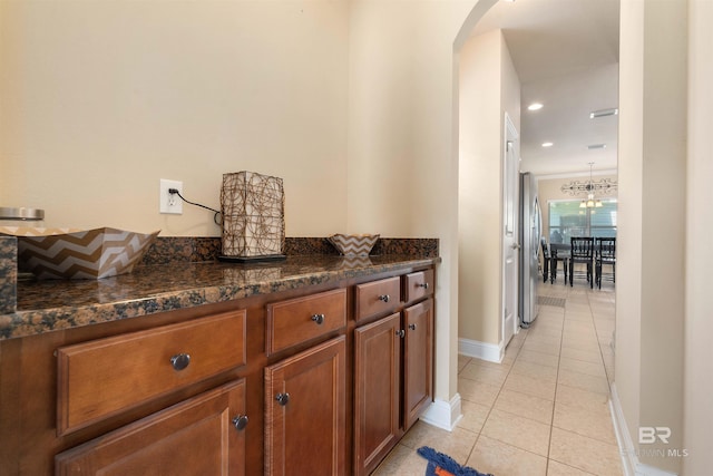267 Galaxy St, Fairhope, AL 36532 - interior space with light tile patterned floors, recessed lighting, arched walkways, freestanding refrigerator, and a notable chandelier