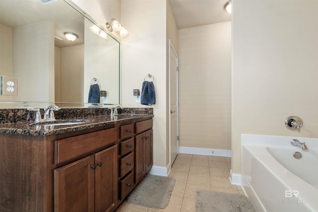 bathroom featuring double vanity, tile patterned flooring, and a tub to relax in