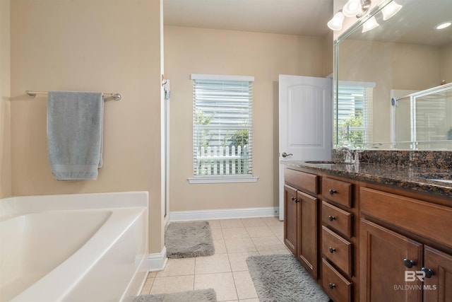 267 Galaxy St, Fairhope, AL 36532 - full bath featuring double vanity, a sink, tile patterned flooring, a shower stall, and a garden tub