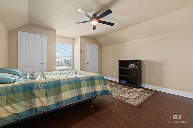 bedroom featuring vaulted ceiling, a textured ceiling, ceiling fan, and hardwood / wood-style floors