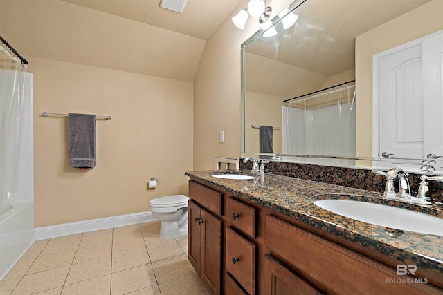 bathroom featuring double vanity, tile patterned flooring, a textured ceiling, lofted ceiling, and toilet