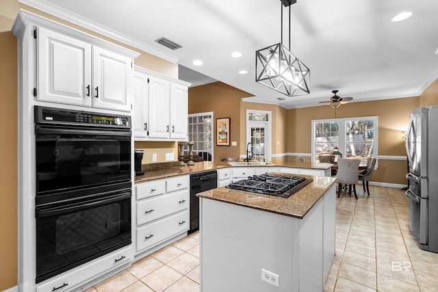 kitchen with black appliances, ornamental molding, kitchen peninsula, and white cabinets