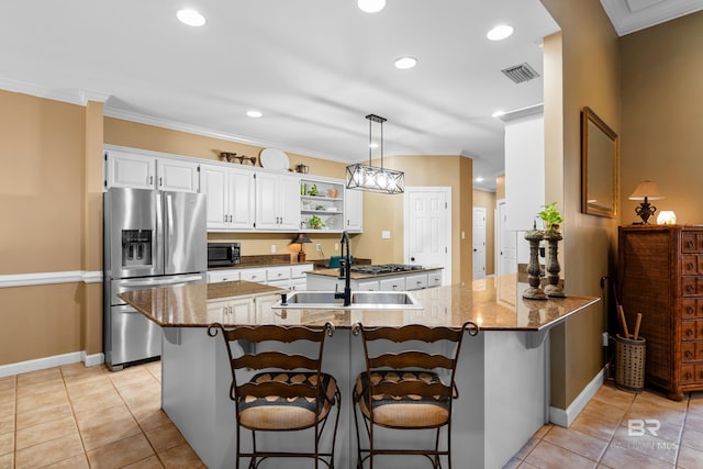 kitchen featuring a breakfast bar, white cabinetry, stainless steel appliances, and kitchen peninsula