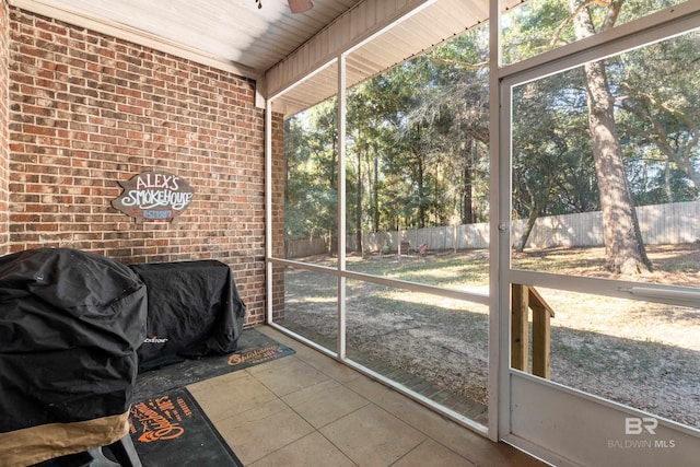 sunroom / solarium with wooden ceiling and ceiling fan