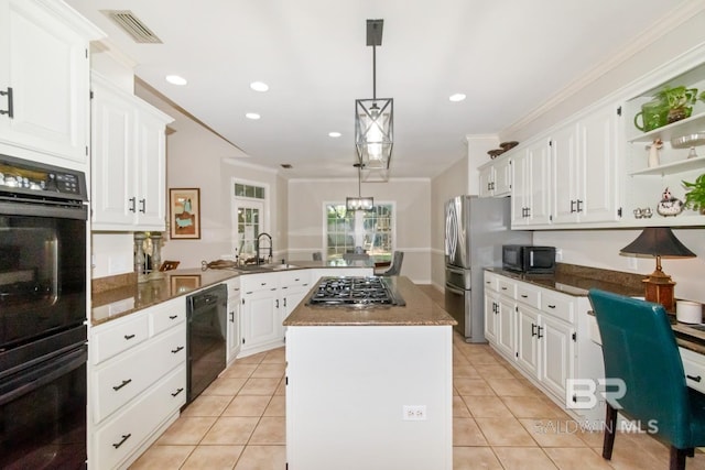8814 N Dawes Lake Rd, Mobile, AL 36619 - kitchen featuring a peninsula, black appliances, visible vents, crown molding, and a center island