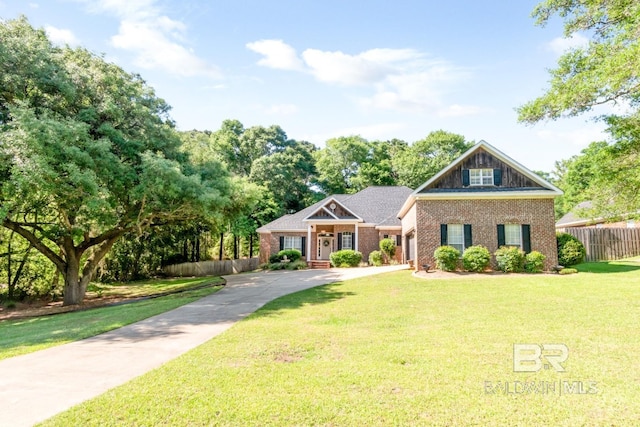 8814 N Dawes Lake Rd, Mobile, AL 36619 - craftsman-style home with a front yard, driveway, brick siding, and fence