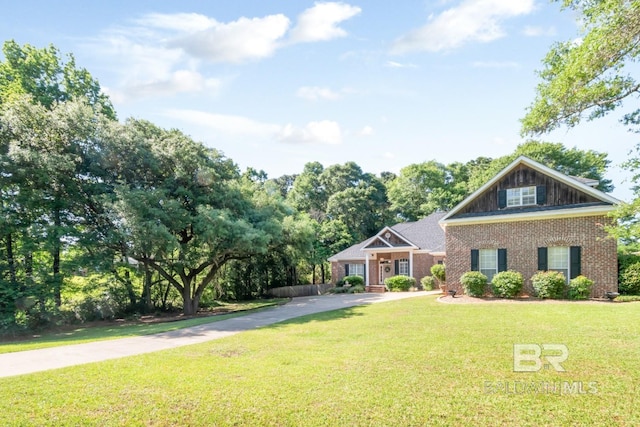 8814 N Dawes Lake Rd, Mobile, AL 36619 - craftsman house with concrete driveway, brick siding, and a front lawn