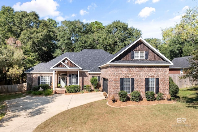 craftsman-style home featuring covered porch, a front yard, and a garage