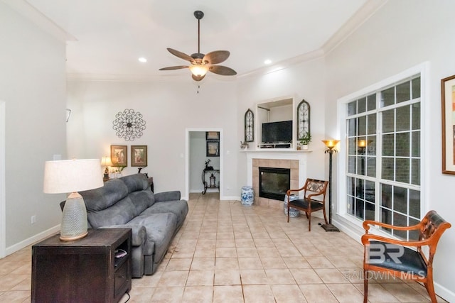 8814 N Dawes Lake Rd, Mobile, AL 36619 - living room with crown molding, light tile patterned floors, a tiled fireplace, and a ceiling fan
