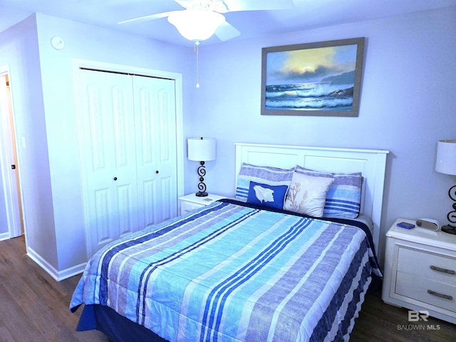 bedroom with dark hardwood / wood-style floors, a closet, and ceiling fan