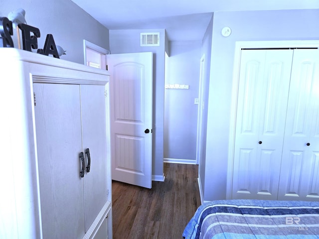 bedroom featuring dark hardwood / wood-style flooring and a closet