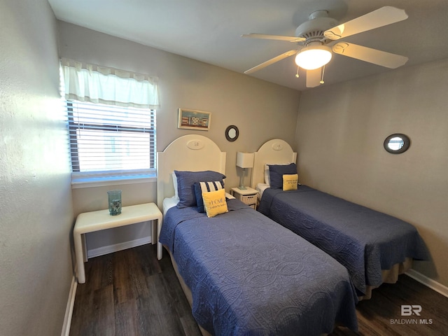 bedroom featuring ceiling fan and dark wood-type flooring