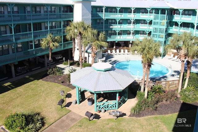 view of pool featuring a yard and a patio