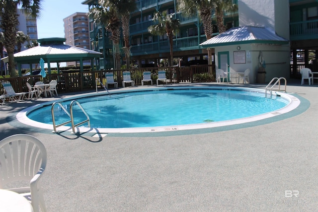 view of swimming pool with a gazebo and a patio area