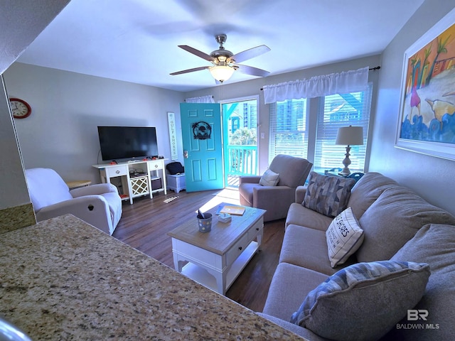 living room featuring dark hardwood / wood-style floors and ceiling fan