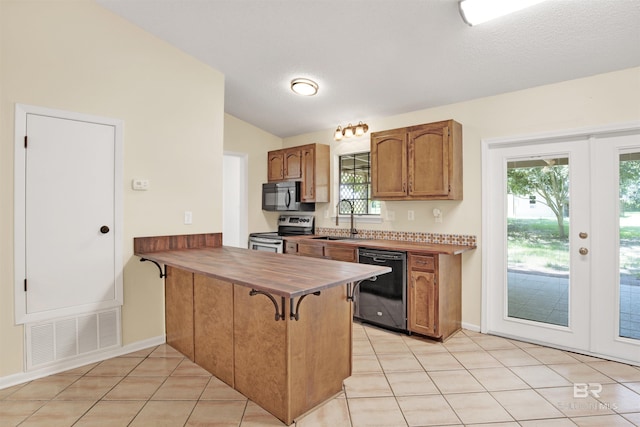 18657 County Road 12, Foley, AL 36535 - kitchen featuring black appliances, a sink, lofted ceiling, a peninsula, and light tile patterned flooring