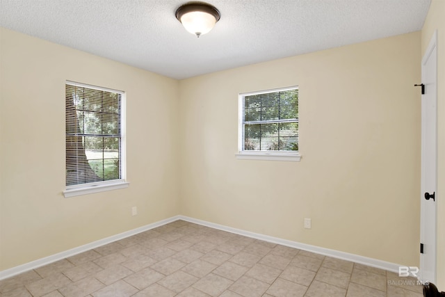 18657 County Road 12, Foley, AL 36535 - spare room with a textured ceiling, baseboards, and light tile patterned floors