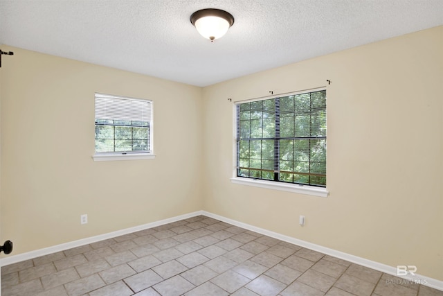 18657 County Road 12, Foley, AL 36535 - unfurnished room with a textured ceiling, baseboards, and light tile patterned floors