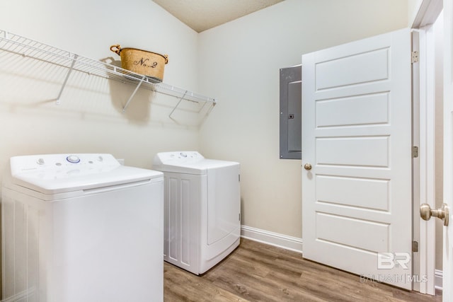 11547 Thistledown Loop, Spanish Fort, AL 36527 - washroom featuring washing machine and dryer, electric panel, wood finished floors, and baseboards